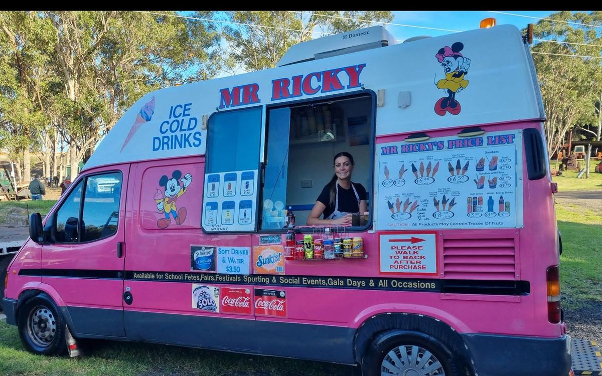 The Mr Ricky ice cream van with Christine serving from the window, price list alongside